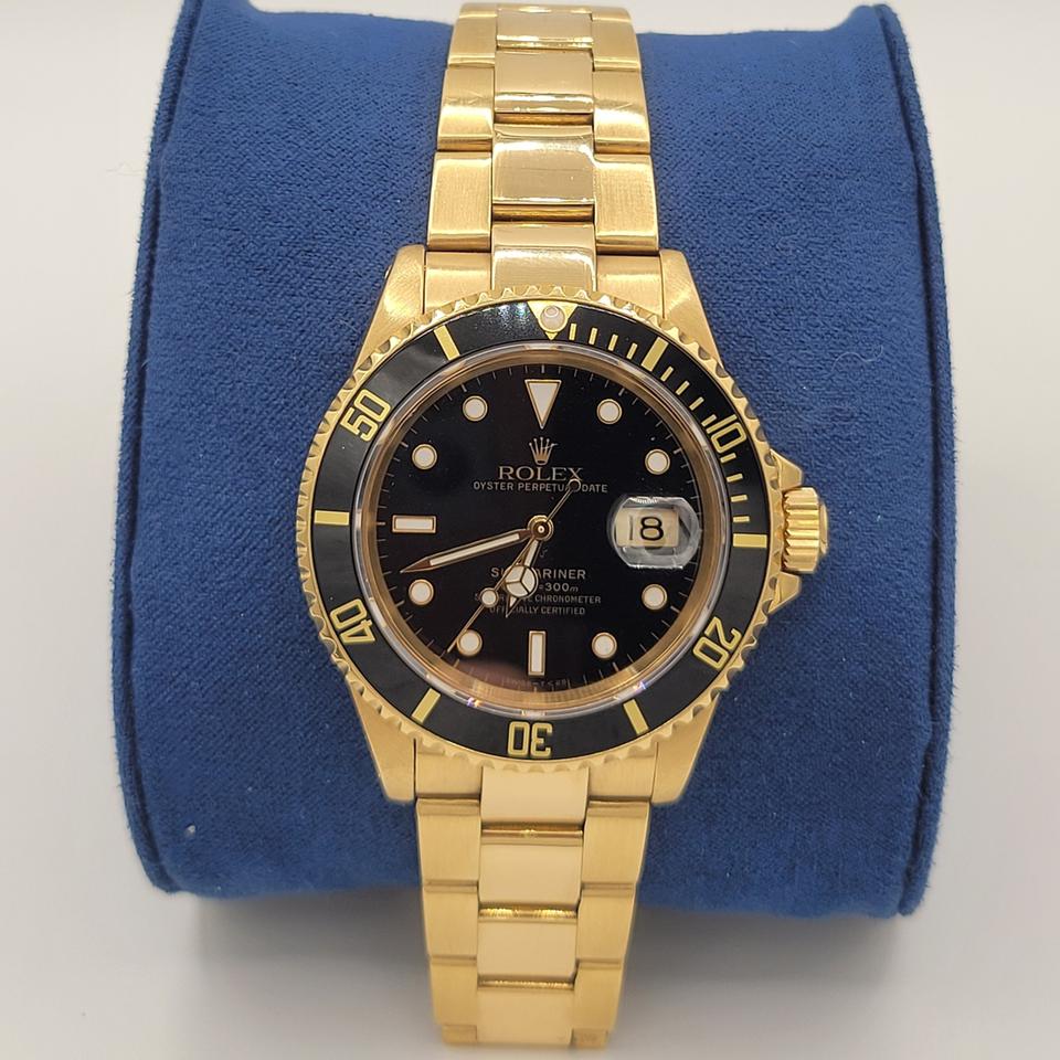 Submariner Date automatic luxury watch with black dial and yellow gold bracelet