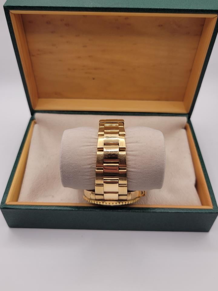 Submariner Date automatic luxury watch with black dial and yellow gold bracelet